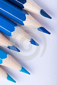 Macro photograph of several pencils of blue color on a white background