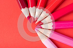 Macro photograph of several pencils of red color on a paper background