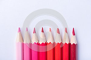 Macro photograph of several pencils of red color on a white background