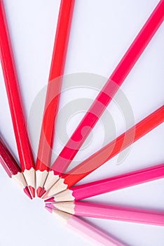 Macro photograph of several pencils of red color on a white background