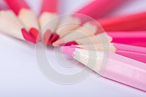 Macro photograph of several pencils of red color on a white background