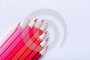 Macro photograph of several pencils of red color on a white background