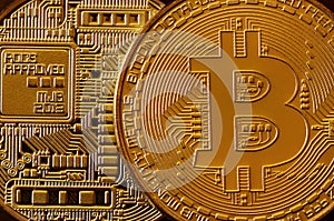 Macro photography of a golden yellow metal bitcoin. Close up shiny metal texture. Abstract business and modern technology backgro