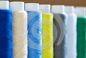 macro photography of multi-colored skeins of thread for sewing