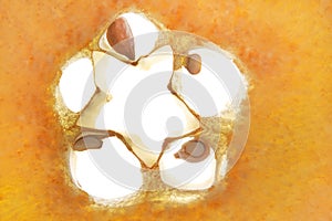 Macro photography of orange quince. Cut in half inside the longitudinal section has the shape of a star. A piece of