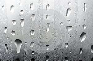 Macro photography water drops on glass window white background after the rain.
