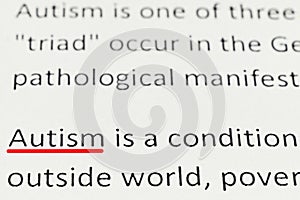 Macro photography of the word autism from the newspaper