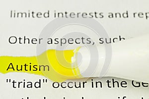 Macro photography of the word autism from the newspaper