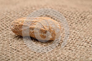 Macro picture of a peanut in a shell on a jute background