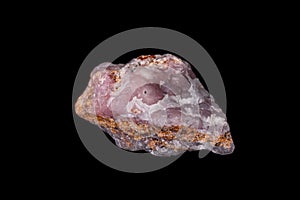 Macro pink Smithsonite mineral stone on microcline on black background