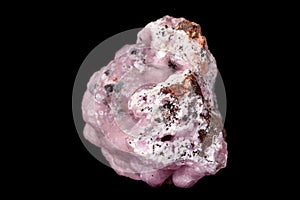 Macro pink Smithsonite mineral stone on microcline on black background