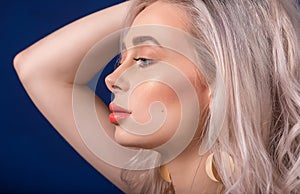 Macro of Platinum Blonde Hair Woman With Blue Eyes and Augmented Lips, Painted With Coral Lipstick, from Profile