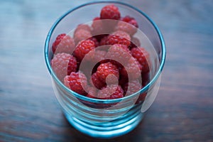 Macro raspberries in glass, with blue filter