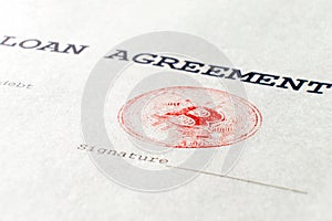 Macro. Red stamp of virtual currency bitcoin on a financial document. The loan agreement, the signature is printed on a real sheet