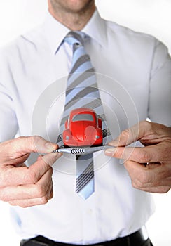 Macro red toy car in businessman necktie