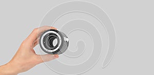 Macro rings for a camera in a male hand on a gray background