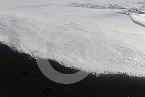 Macro sea foam on Icelandic black sand