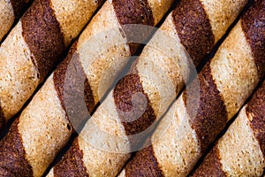 Macro selective focus on chocolate wafer rolls. Chocolate sticks background