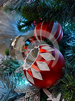 Pine cones, snowflakes, peppermints, and other ornaments decorating a Christmas tree for the holiday photo