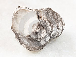 raw cacholong stone on white photo