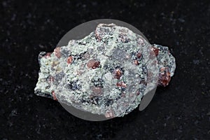 raw eclogite stone on dark g background photo