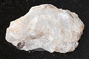 rough belomorite stone on dark background photo