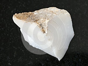 rough cacholong (white opal) stone on dark