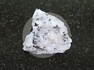 rough Diorite stone on dark background photo