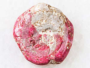 tumbled Thulite gemstone on white photo