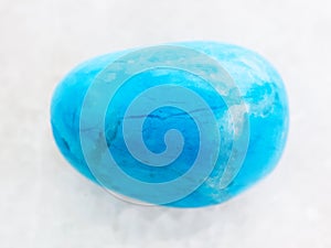 tumbled Turquenite (blue howlite) stone on white photo