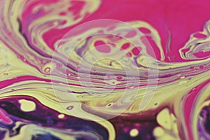 Macro shot of an abstract background of colorful acrylic paint and poured oil mixture