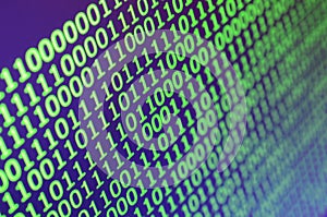 Macro shot of binary code on the monitor of an office computer. The concept of the programmer`s work. The flow of digital informa