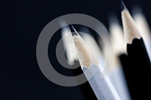 Macro shot of black and white wooden pencil tips