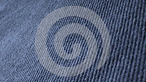 Macro shot of blue denim fabric. Casual wear material. Vintage texture surface