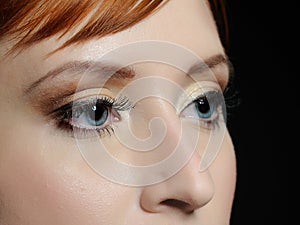 Macro shot of blue eyes with long lashes