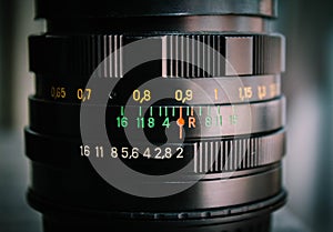 Macro shot of a camera lens focusing on camera lens information the aperture size