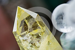 Macro shot of citrine stone and crystal balls on colorful background