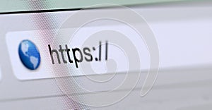 Macro shot of computer screen with https:// address bar and web