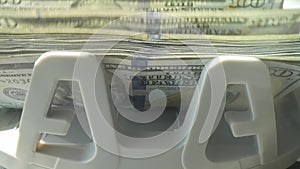 Macro shot counter counting dollar bills. Money counting machine with 100 dollar banknotes. Bank currency and finance