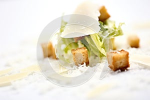macro shot of a crouton and parmesan on caesar salad