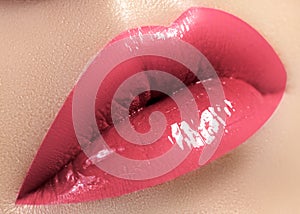 Macro shot with cute Female Lips. Light daily color for lip Make-up. Fashion Makeup, trend cosmetic. Pink lipgloss