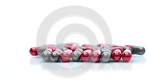 Macro shot detail of red and grey capsule pills isolated