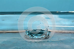 Macro shot of drops making ripples in water
