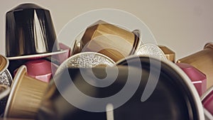 Macro shot of espresso capsules in various colors and flavors