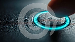 A macro shot of a finger pressing a glowing blue illuminated circular button on a textured dark surface, symbolizing technology