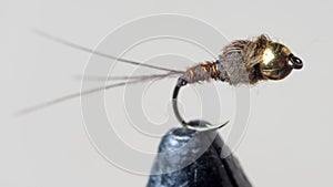 Macro shot of fly fishing lure on a white background, hand made fly for fishing