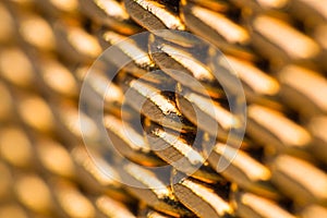 macro shot of a golden metal watch strap