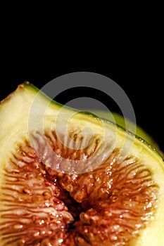 Macro shot of a half fig on a dark background