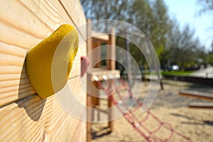 Macro shot of a handle on a freeclimbing wall on a public wooden playground in Berlin photo