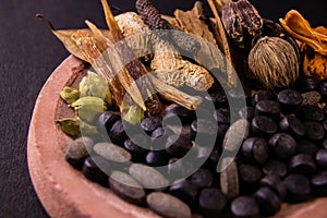 Macro shot of herbs and spices with herbal medicines on a grinding stone. Unani concept